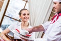 Waiter brings a dish for a nice woman Royalty Free Stock Photo