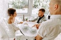 Waiter brought cup of coffee for beautiful couple in a cafe