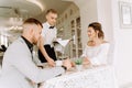 Waiter brought cup of coffee for beautiful couple in a cafe Royalty Free Stock Photo