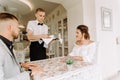 Waiter brought cup of coffee for beautiful couple in a cafe Royalty Free Stock Photo