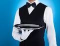 Waiter carrying empty tray