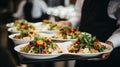 Waiter carrying a plate of food on some festive event, party or wedding reception Royalty Free Stock Photo