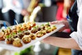 Waiter carrying plates with meat dish on festive event, party or wedding reception Royalty Free Stock Photo