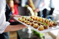 Waiter carrying plates with meat dish