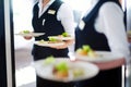 Waiter carrying plates with meat dish