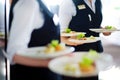 Waiter carrying plates with meat dish on some festive event Royalty Free Stock Photo