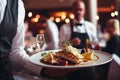 Waiter carrying plates with meat dish on some festive event, party or wedding reception restaurant. Generative AI. Royalty Free Stock Photo