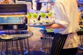 Waiter carrying plates with salad seafood in glass on some festive event, party or wedding reception