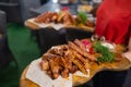 Waiter carrying two plates with meat dish on some festive event, party, wedding reception or catered event. Royalty Free Stock Photo