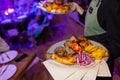 Waiter carrying two plates with meat dish on some festive event, party, wedding reception or catered event. Royalty Free Stock Photo