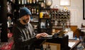 Waiter cashing up at antique cash register in an old traditional restaurant in Toledo Spain Royalty Free Stock Photo