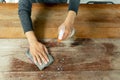 Waiter cleaning the table with spray disinfectant in cafe. Royalty Free Stock Photo