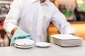 Waiter drying dishes in the restaurant. Royalty Free Stock Photo