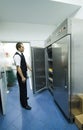 Waiter and commercial fridges or refrigerators Royalty Free Stock Photo