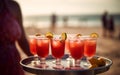 waiter girl holding cocktails and soft drinks on a tray