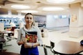 Waiter girl holding menu at cafe. People and service concept