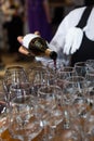 the waiter girl pours red wine into glasses Royalty Free Stock Photo