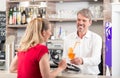 Waiter giving cocktail to woman