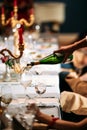 Waiter hand pouring wine in a glass served table Royalty Free Stock Photo