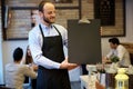 Waiter holding blackboard