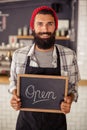 Waiter holding a board written open