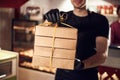 Waiter is holding bunch of paper eco boxes in the cafe. Order is ready Royalty Free Stock Photo