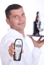 Waiter holding cell phone Royalty Free Stock Photo