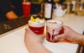 Waiter holding Famous Glass juicy craft cocktails with decorative Author inspired Cocktail Drink on bar counter . Close-up Top Royalty Free Stock Photo