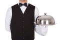 Waiter holding metal cloche lid cover on tray