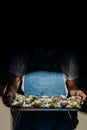 waiter holding a metal tray fresh raw oysters with lime, lemon and ice. raw opened oyster, lifestyle food, ready to eat. Oyster Royalty Free Stock Photo