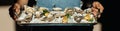 waiter holding a metal tray fresh raw oysters with lime, lemon and ice. raw opened oyster, lifestyle food, ready to eat. Oyster Royalty Free Stock Photo