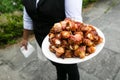A waiter holding a plate full of bacon wrapped scallops - wedding catering series Royalty Free Stock Photo