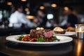 Waiter holding a plate with grilled beef steak with roasted vegetables on a side. Serving fancy food in a restaurant Royalty Free Stock Photo