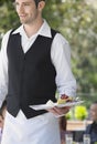 Waiter Holding Slice Of Pie At Cafe