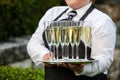 Waiter holding a tray full of drinks during a catered wedding or other special event