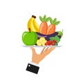 Waiter holds a tray of fresh vegetables and fruit isolated on white background.