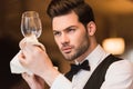 Waiter looking at clean wineglass