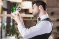 Waiter looking at clean wineglass