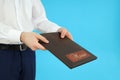 Waiter man give menu on blue background Royalty Free Stock Photo