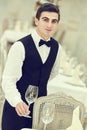 Waiter man serving banquet table at restaurant