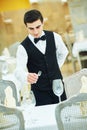 Waiter man serving banquet table at restaurant