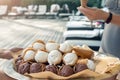 Waiter with metal full tray offer variety of many vanilla and chocolate cone waffle ice cream dessert at pool party