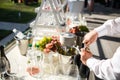 The waiter opens a bottle of alcohol on the table