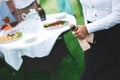 Waiter opens a bottle of champagne, wine.