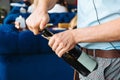 The waiter opens a bottle of drink. Royalty Free Stock Photo