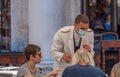 Waiter at the Piazza San Marco in Venice wearing face mask to protect the guests from infection of the Corona virus.