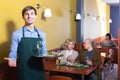 Waiter posing at table customers Royalty Free Stock Photo