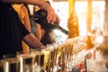 Waiter pouring champagne into glasses on party event in the bar. Royalty Free Stock Photo