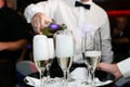 Waiter pouring champagne in glasses at wedding