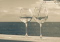 Waiter pouring glass of white wine on outdoor terrace with sea v Royalty Free Stock Photo